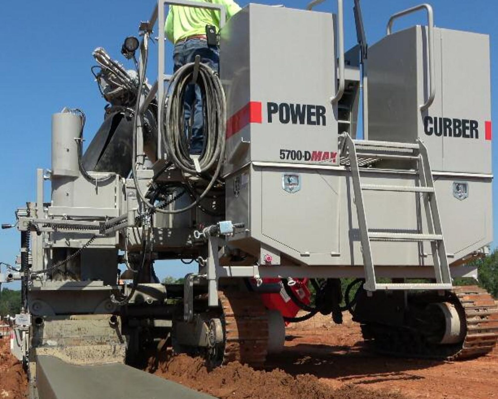 Power Curber 5700-D slipform machine pouring concrete curb & gutter